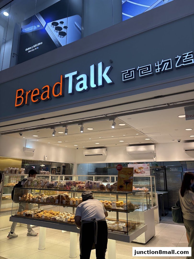 A BreadTalk bakery shop with a display of fresh pastries and bread, and customers browsing.