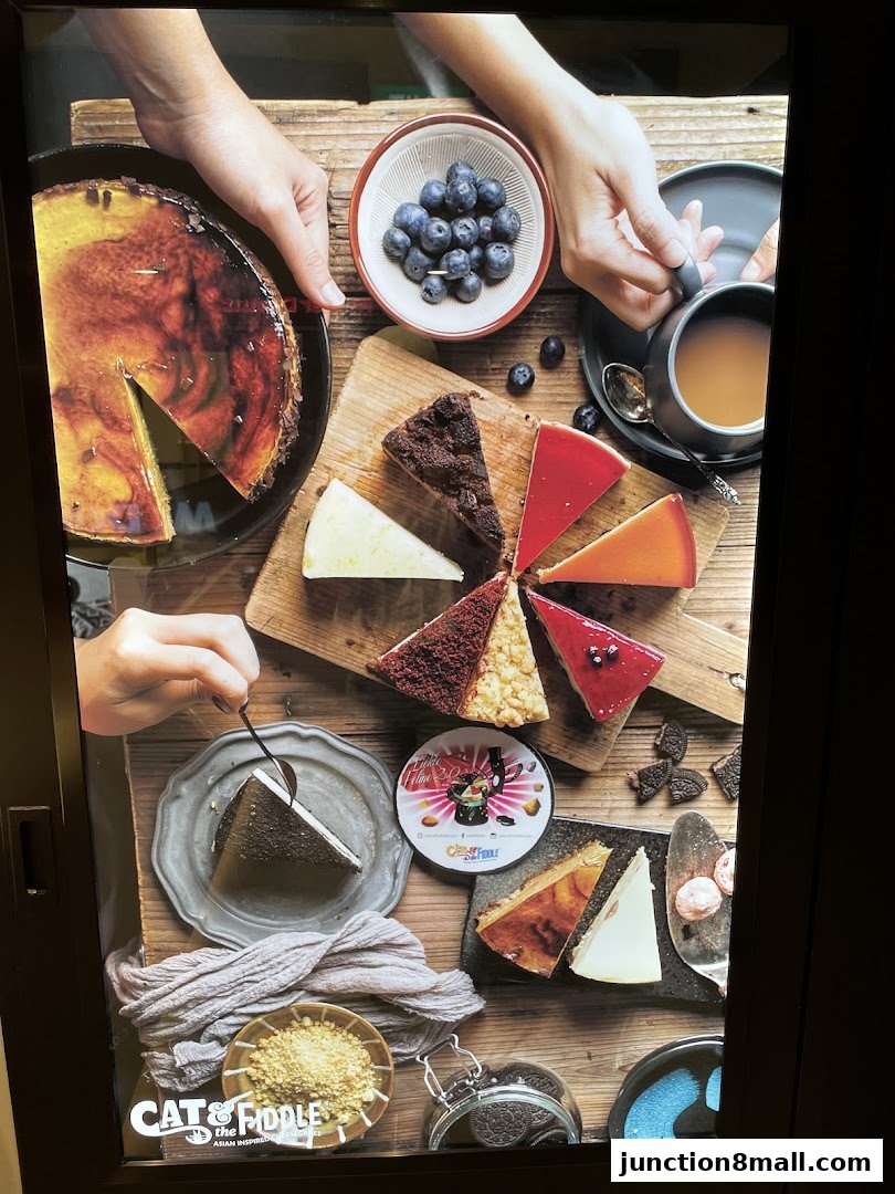 A variety of delicious cheesecakes and desserts are beautifully arranged with fresh blueberries and coffee.