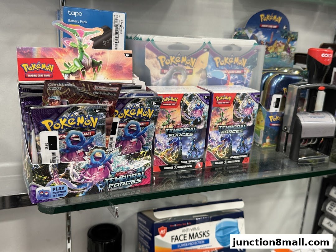 A display of Pokémon trading card game booster packs and boxes, along with other retail items.