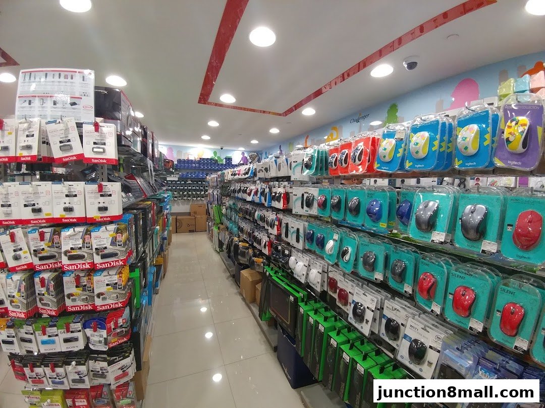 A wide aisle in a tech store showcasing rows of computer mice and USB drives.