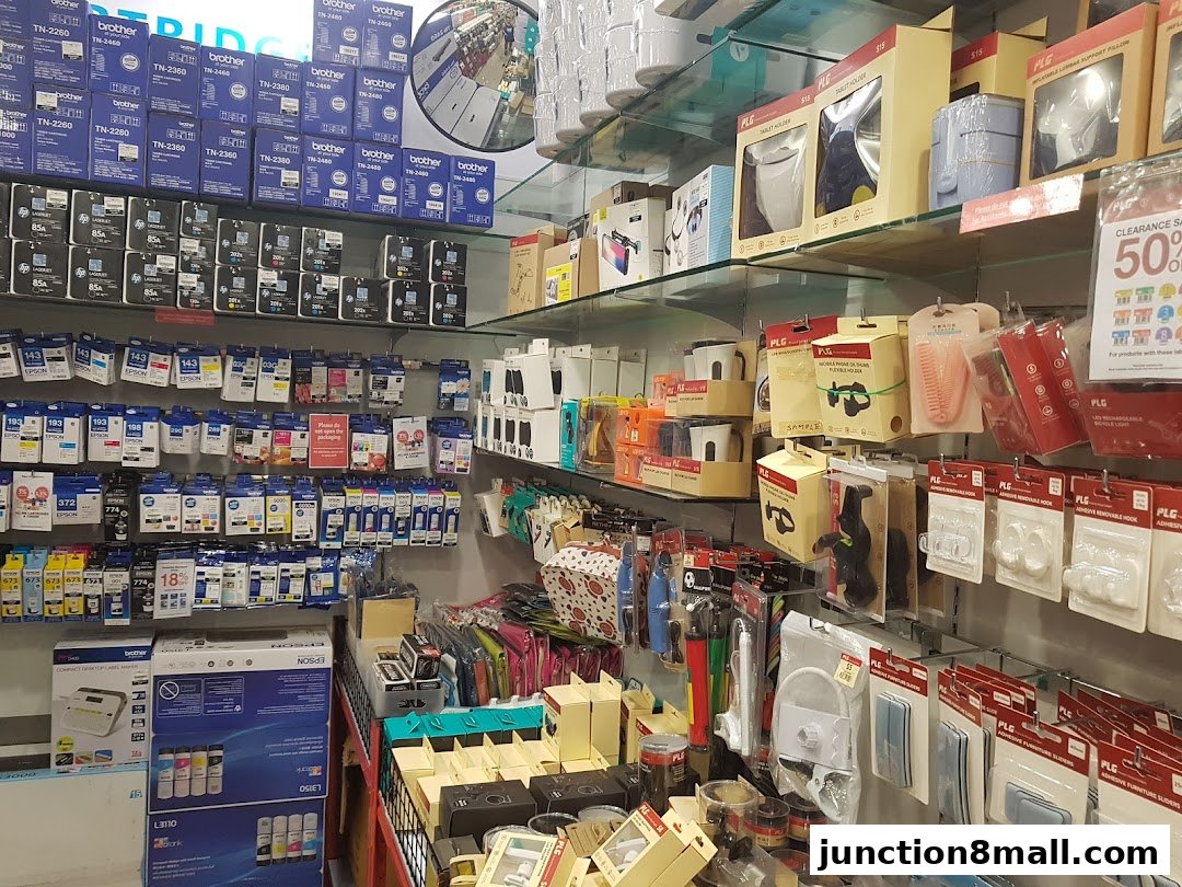 Shelves stocked with printer ink cartridges, toner, and various electronic accessories.