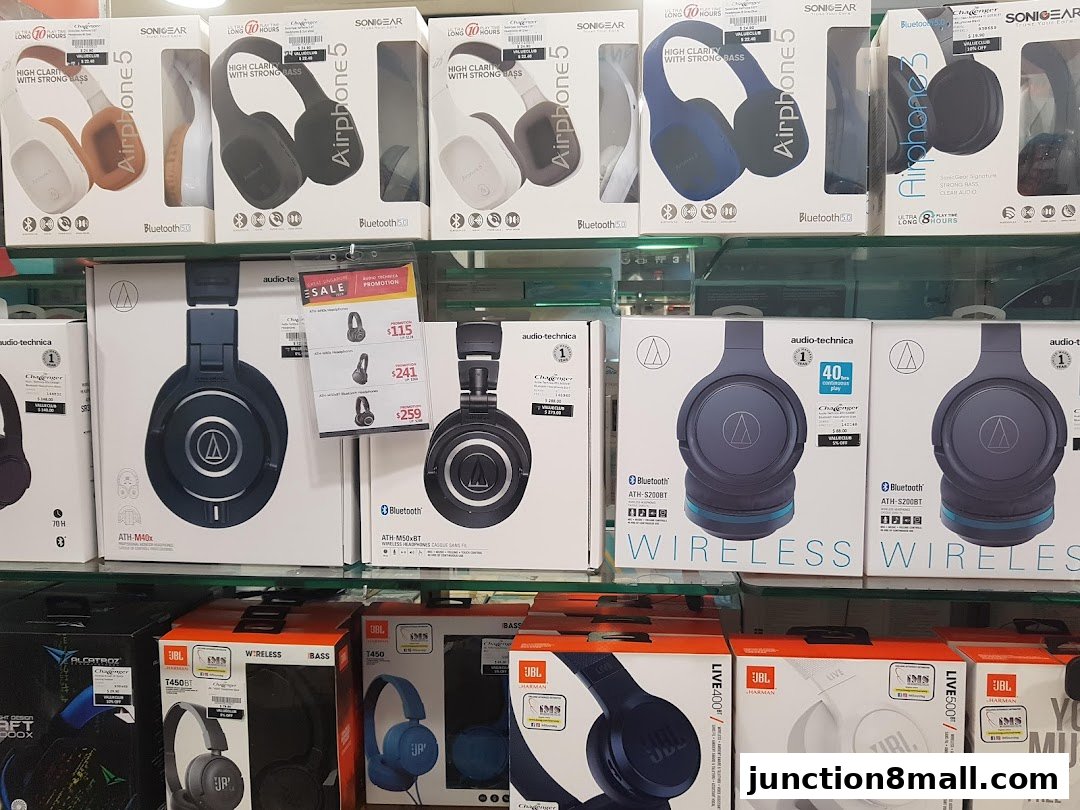 A display of various headphones from brands like Audio-Technica, Sonigear, and JBL.