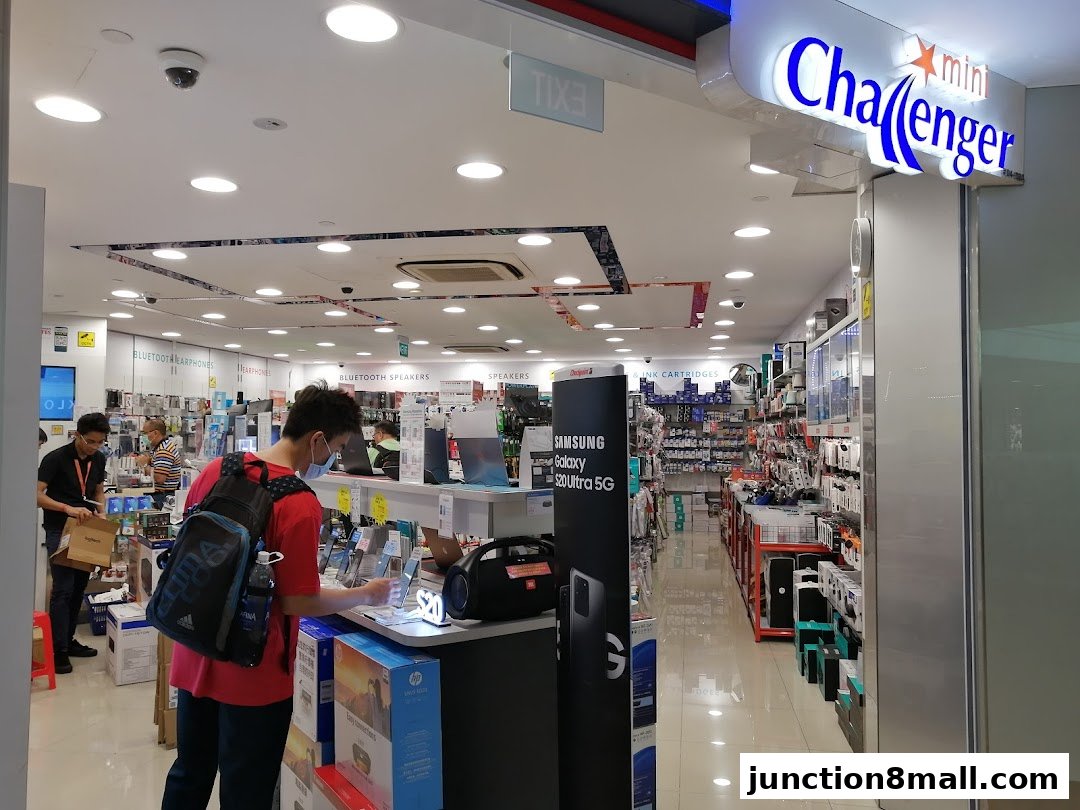 Interior of a Challenger electronics store with customers browsing products.