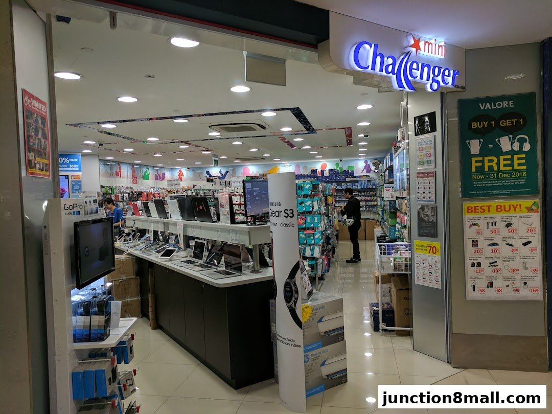The entrance of a Challenger electronics store showcasing various gadgets and promotions.