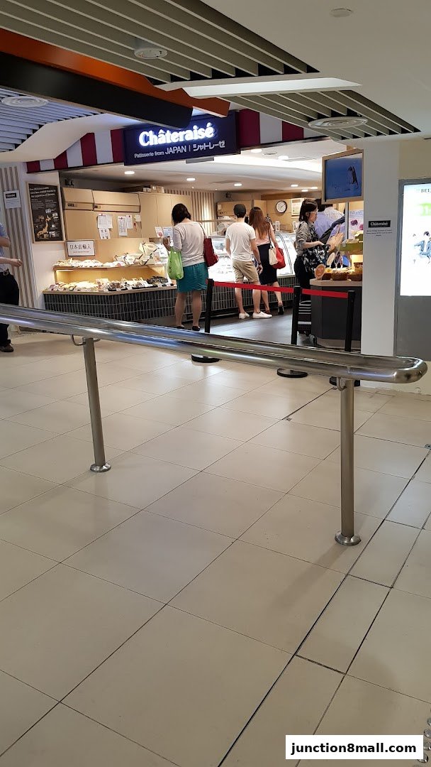 Customers queue at a Châteraisé patisserie, showcasing a variety of baked goods.
