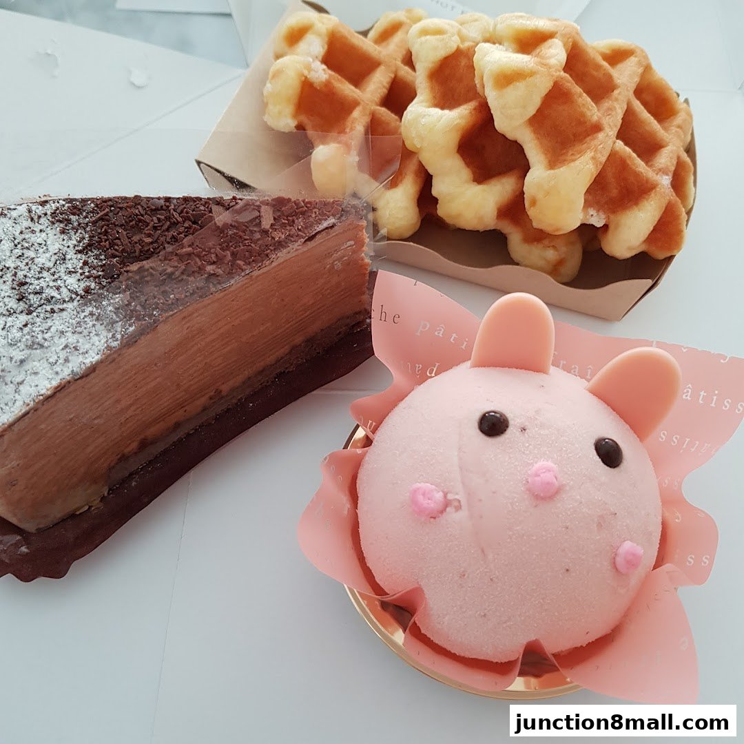 A slice of chocolate cake, waffles, and a cute pink bunny dessert.