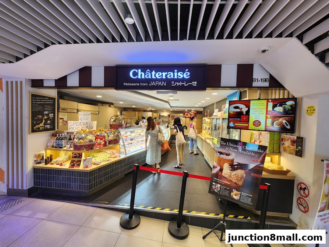 Châteraisé patisserie shop with display cases filled with desserts and promotional posters.