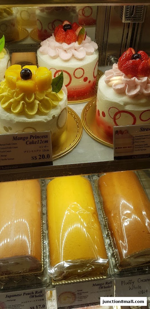 A display case filled with beautifully decorated cakes and rolls from Châteraisé.