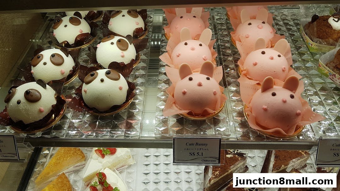A display case filled with adorable panda and bunny-shaped cakes.