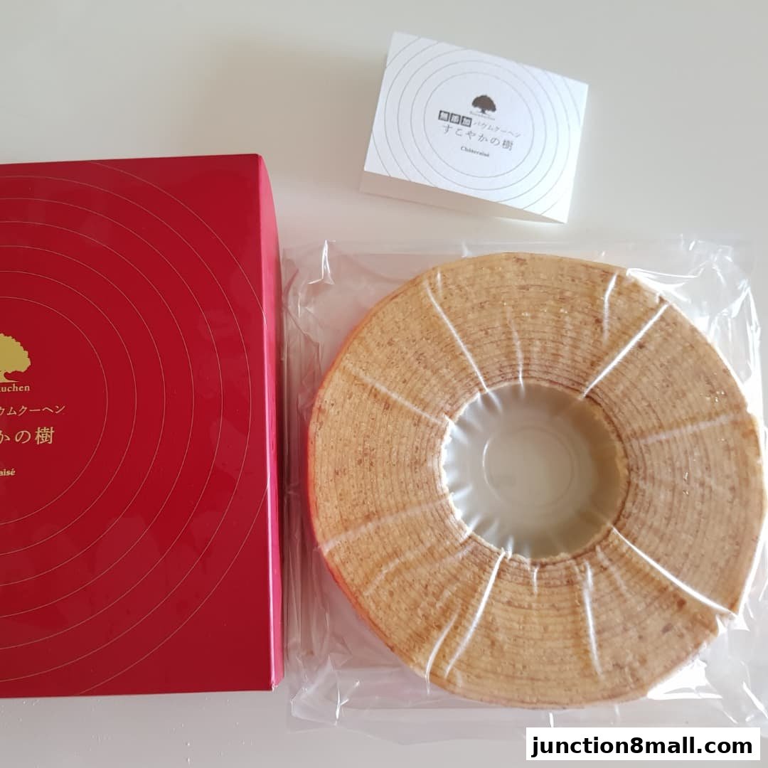 A Baumkuchen cake from Châteraisé in its packaging next to a red gift box.