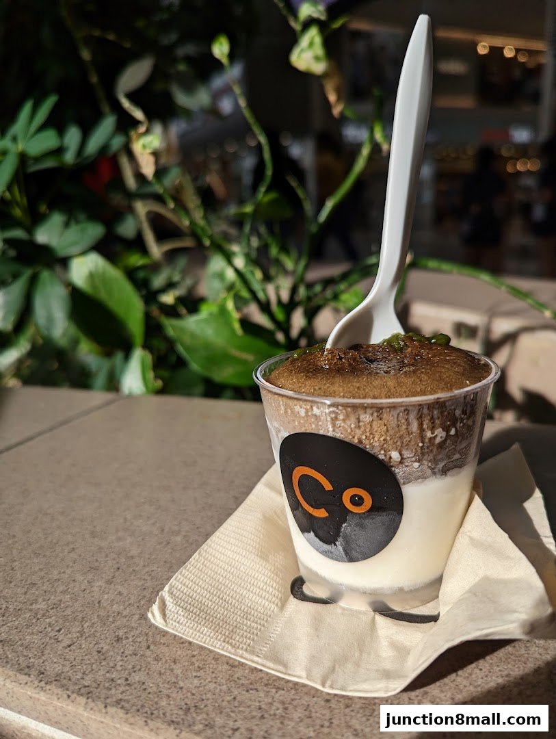 A delicious dessert from Chocolate Origin with a spoon and a napkin.