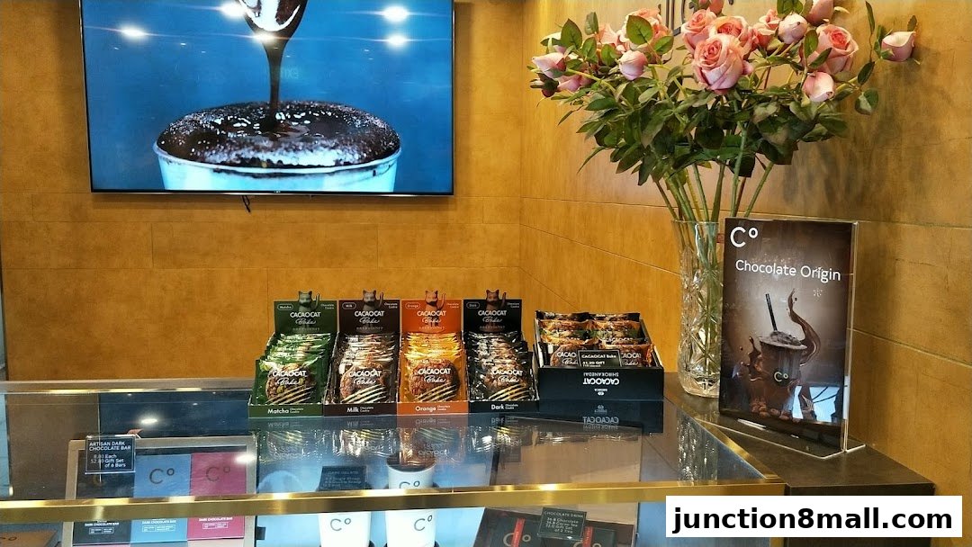 A display of various chocolate products and a promotional sign at Chocolate Origin.