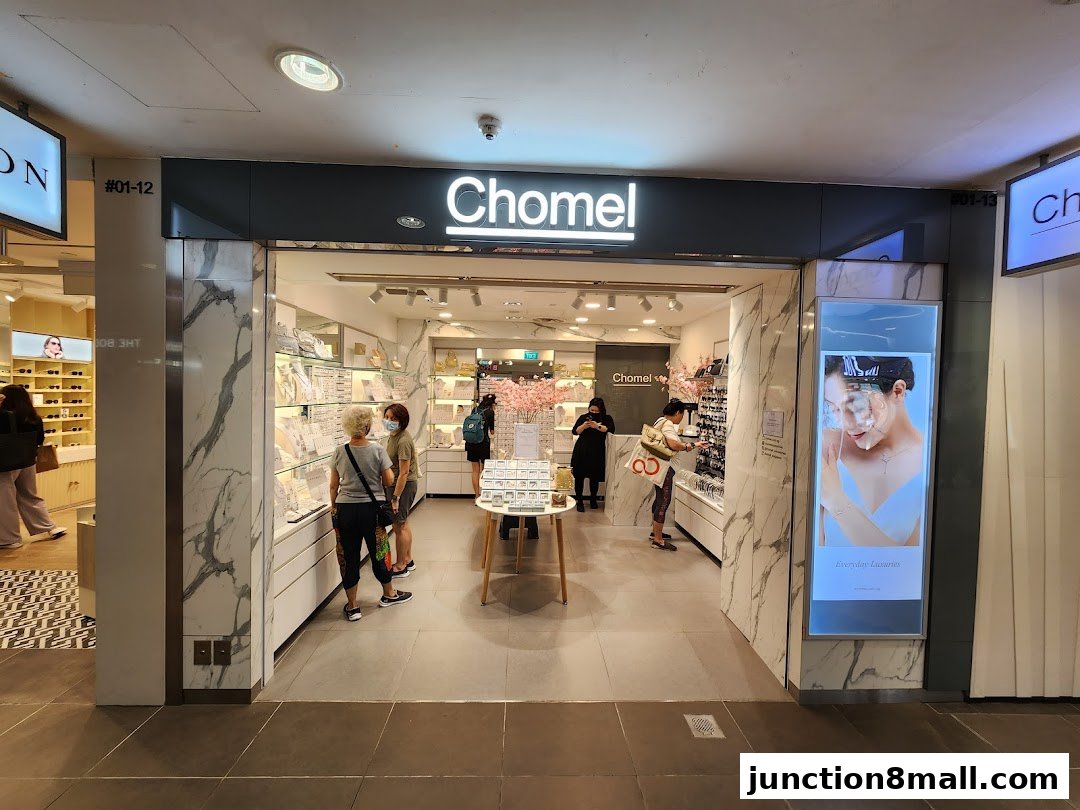 The Chomel store entrance, showcasing jewelry displays and customers browsing.