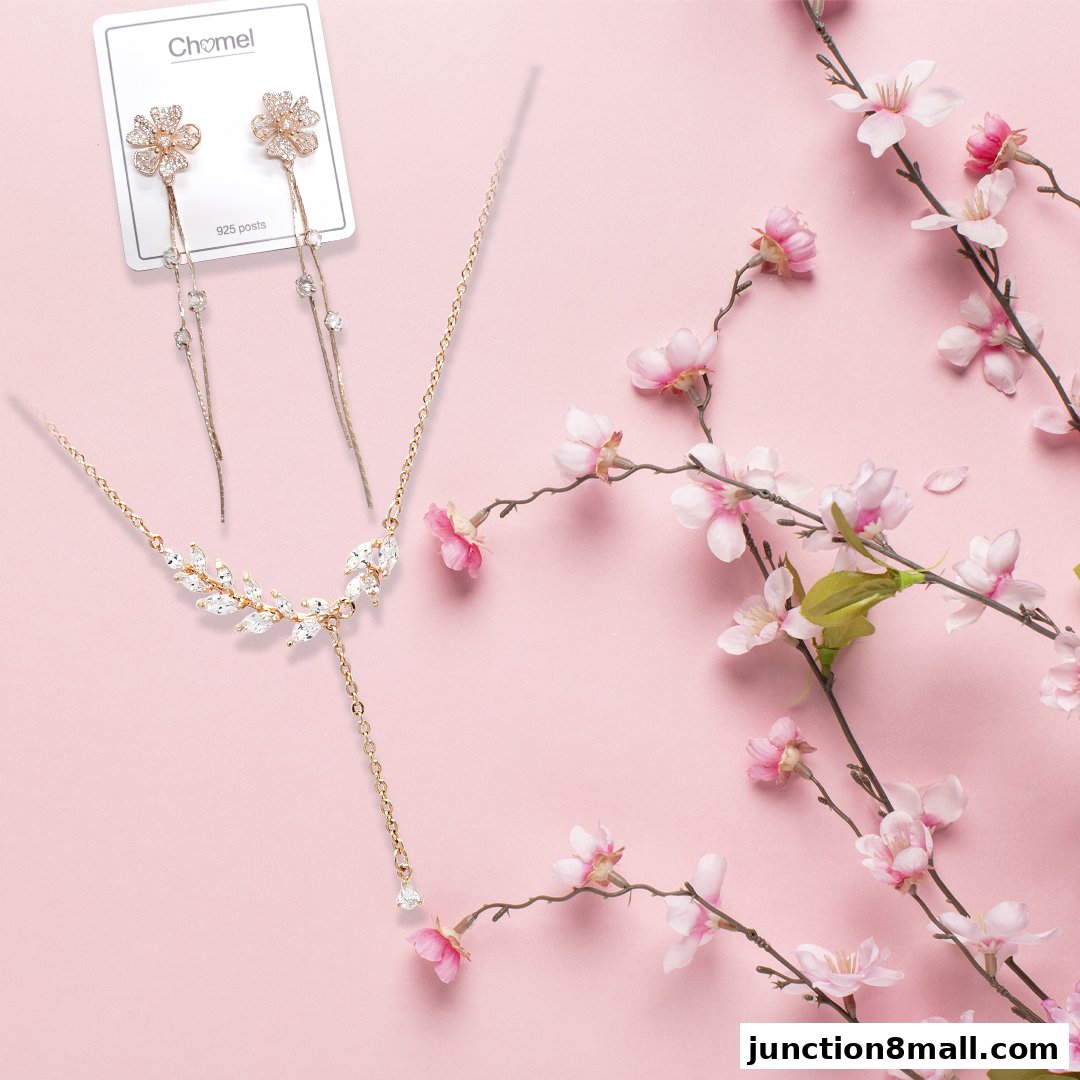 Chomel jewelry set featuring floral earrings and a leaf-shaped necklace with crystals.