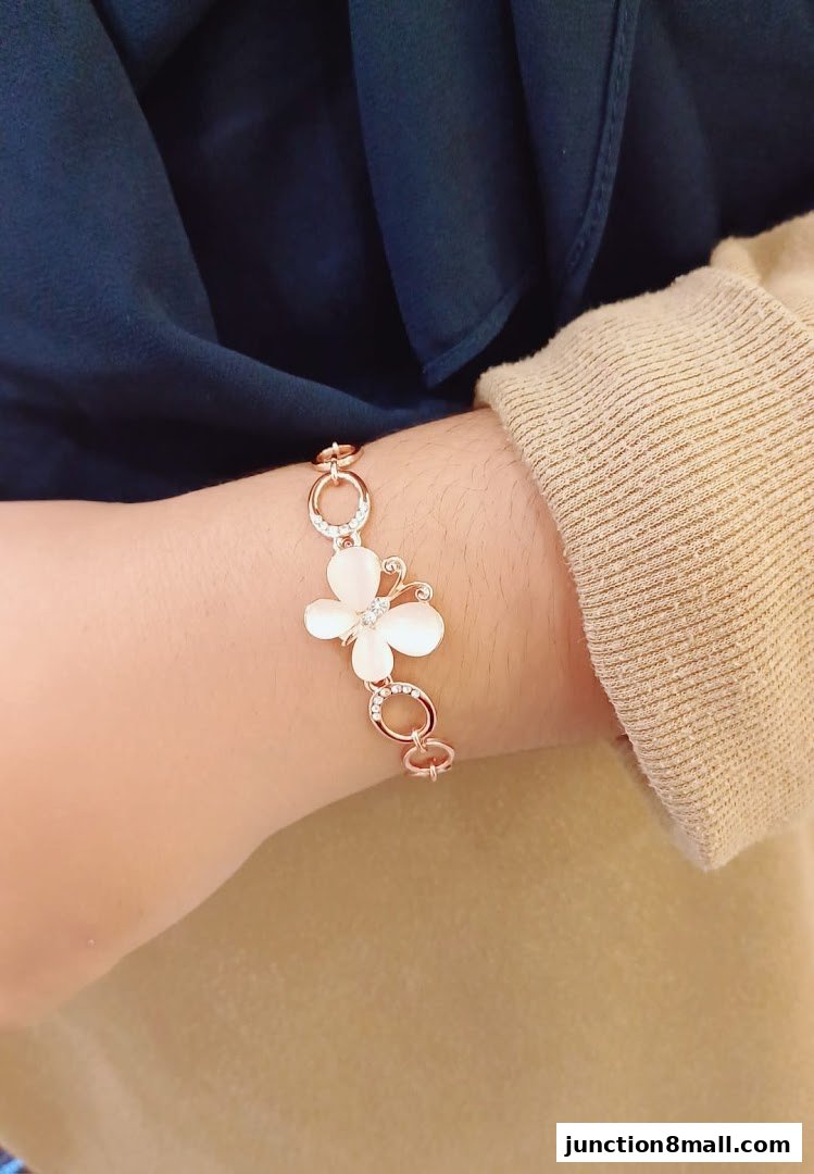 A close-up shot of a delicate butterfly bracelet on a person's wrist.
