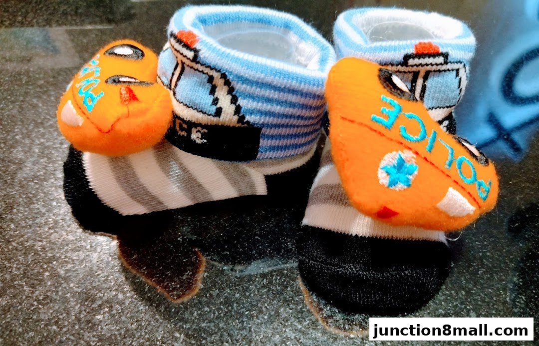 Close-up of cute baby socks with police car and 'POLICE' designs.