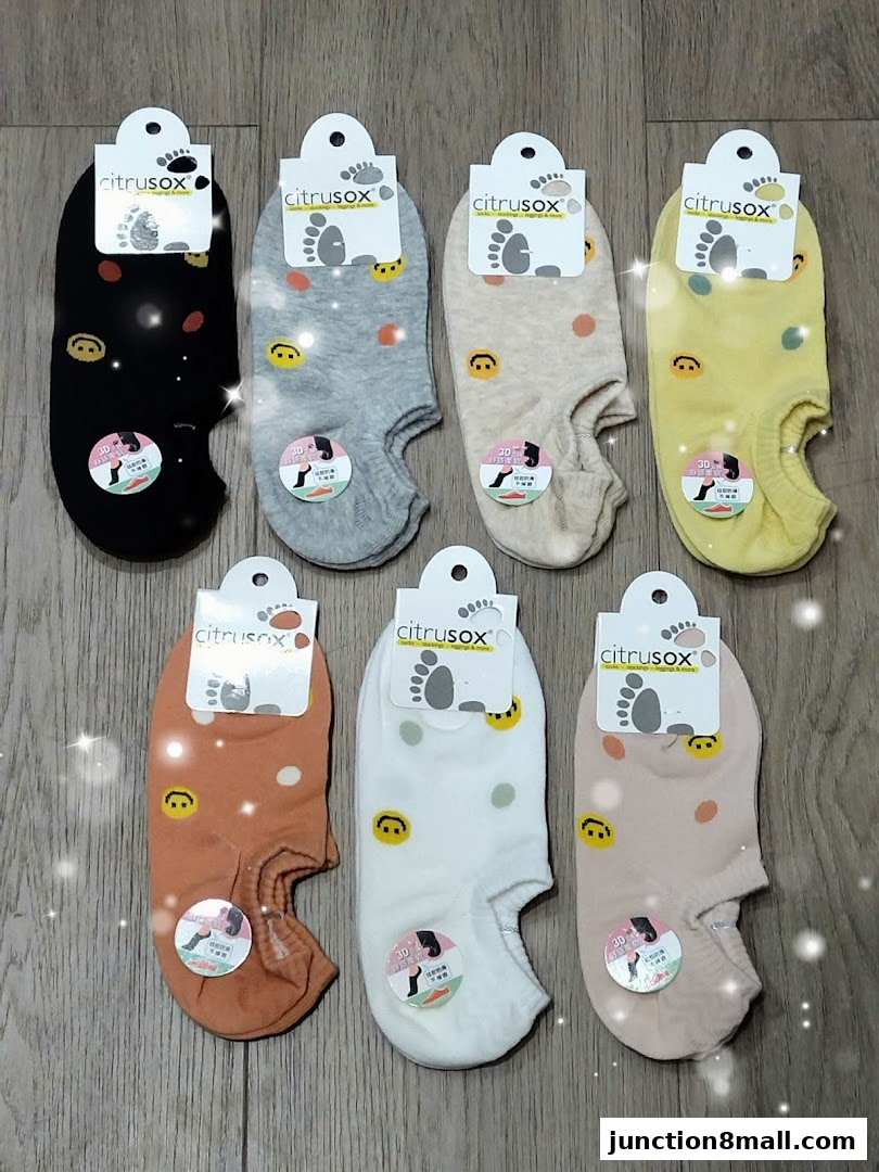 A collection of colorful no-show socks with smiley face and polka dot patterns.