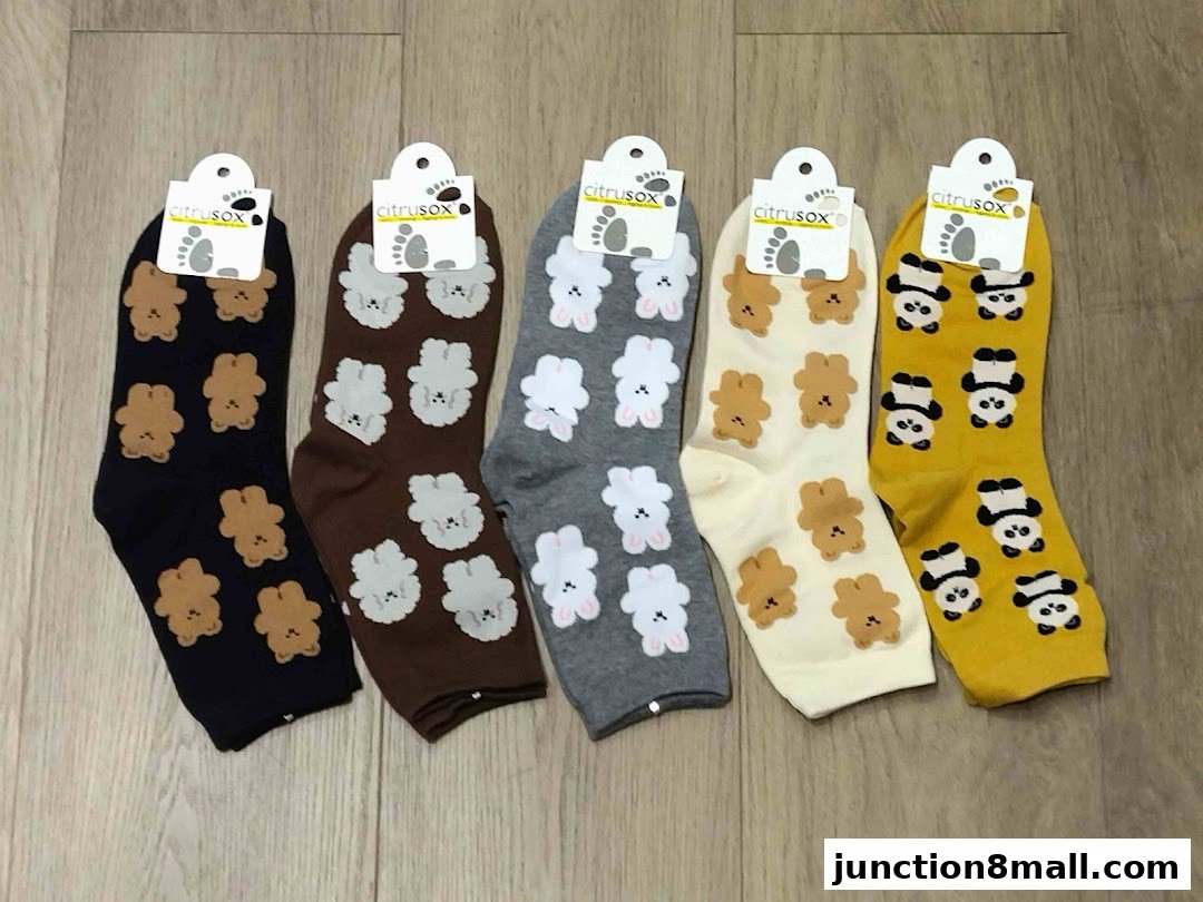Five pairs of socks with cute animal patterns in various colors.