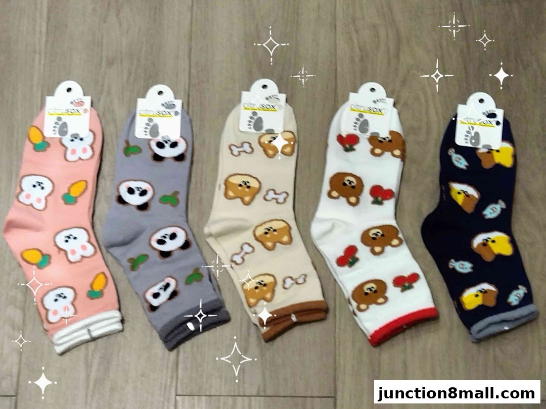 A collection of five pairs of socks with cute animal and food patterns.