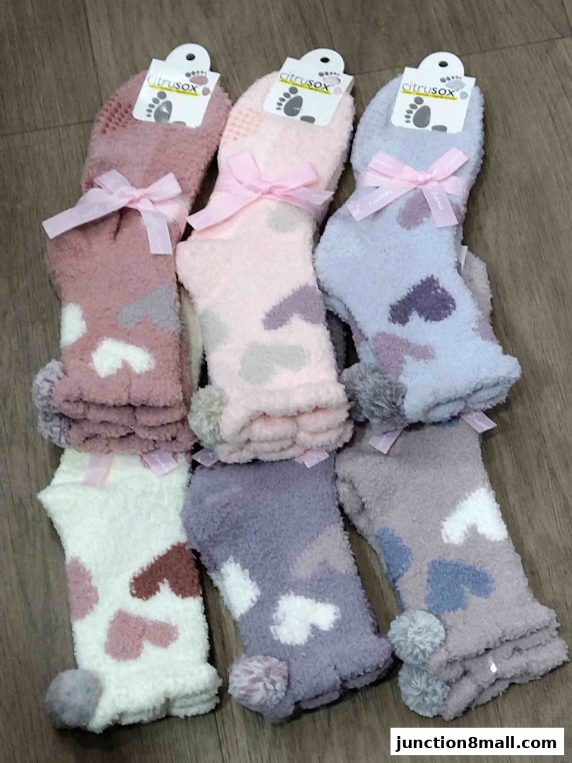 A collection of cozy, fluffy socks with heart patterns and bows.