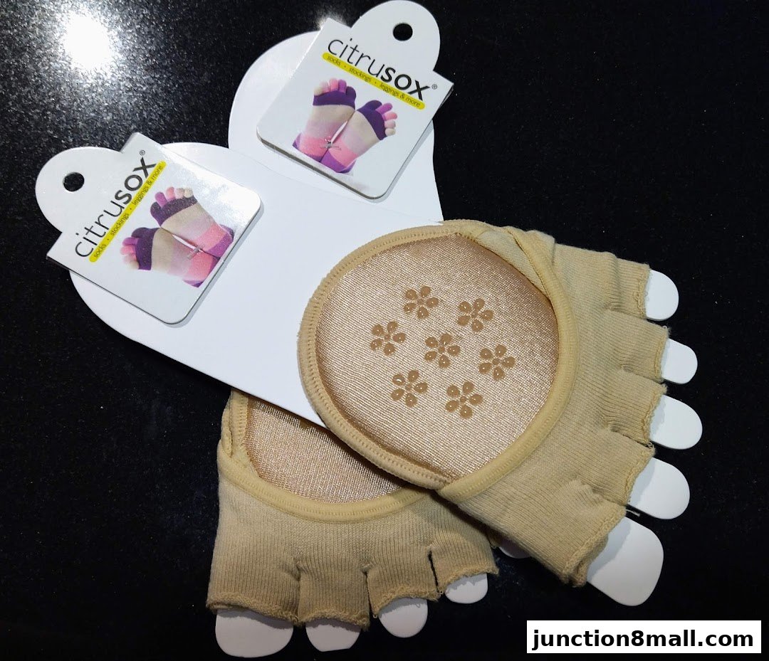 A pair of beige, open-toe socks with floral grip patterns on the soles.