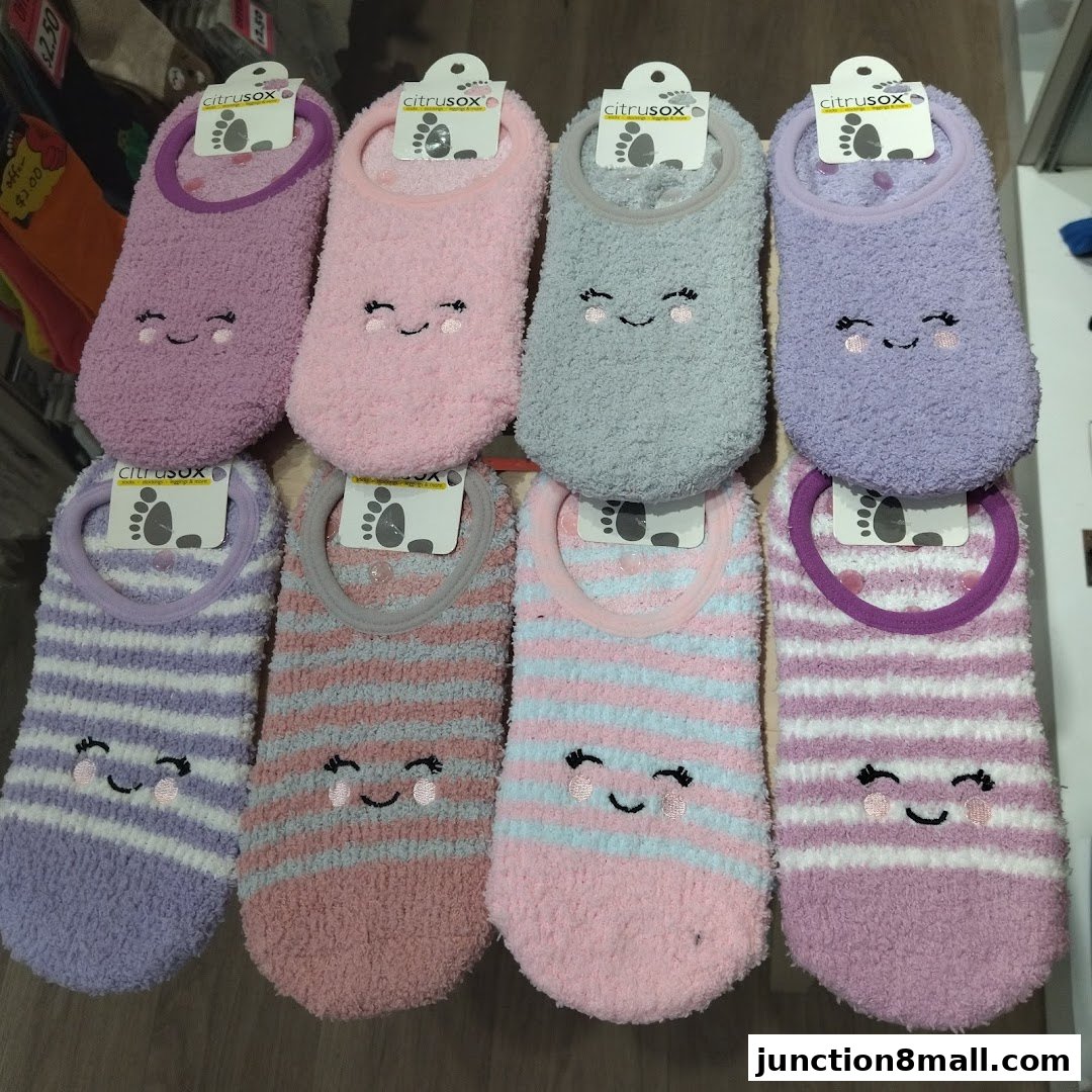A display of cozy, fuzzy socks with cute smiley face designs in various colors.