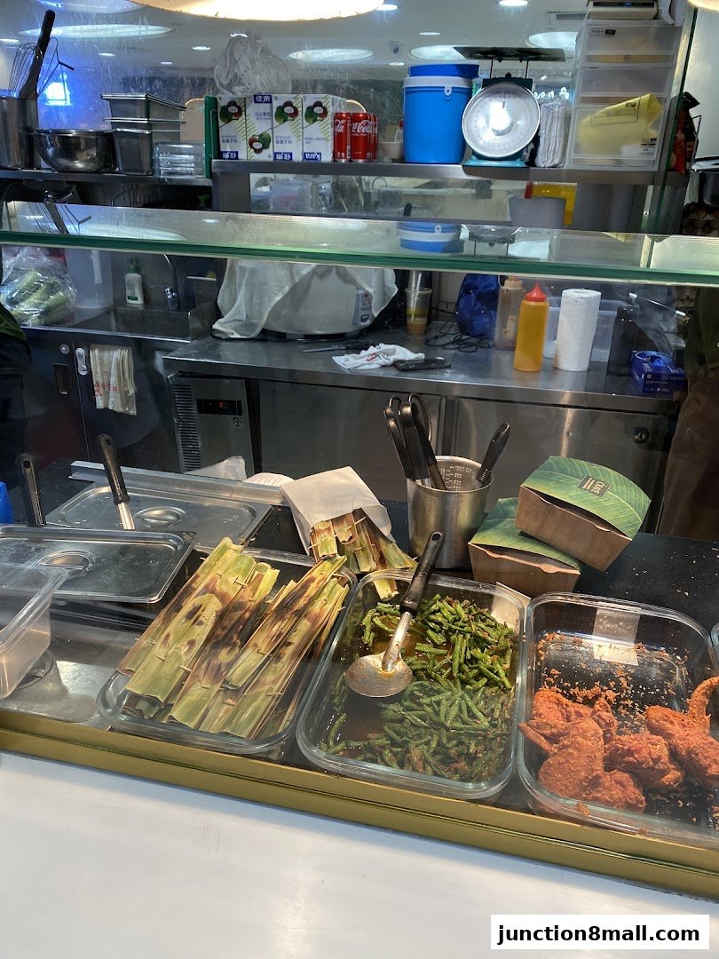 A display of various food items, including grilled items, stir-fried vegetables, and fried chicken.