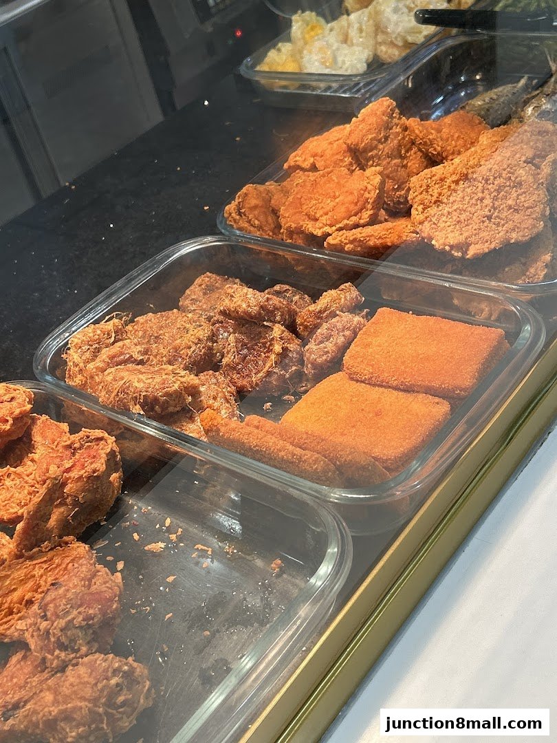 A display of various fried food items, including chicken and other savory snacks.