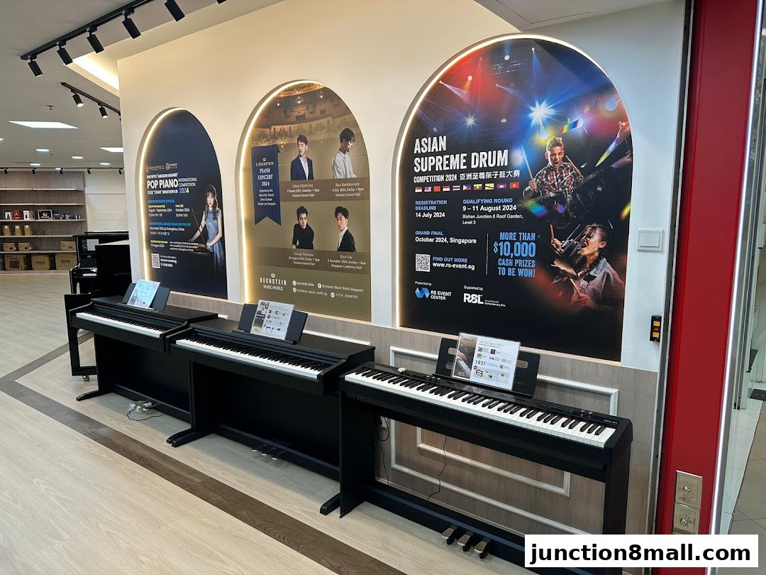 Digital pianos are displayed in a music school with posters advertising piano and drum competitions.