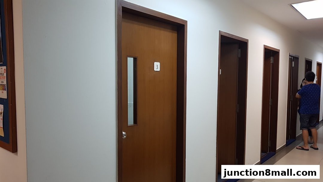 A hallway with several closed wooden doors, one labeled with the number 3.
