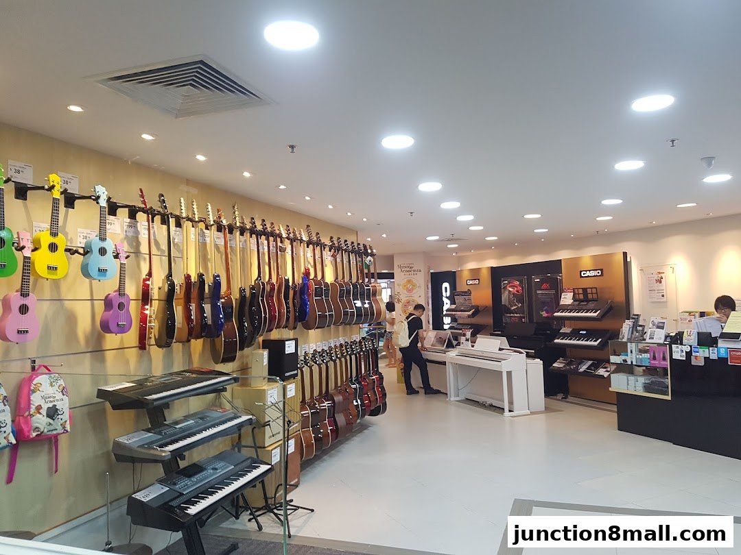 Interior view of a music store showcasing guitars, ukuleles, and keyboards.