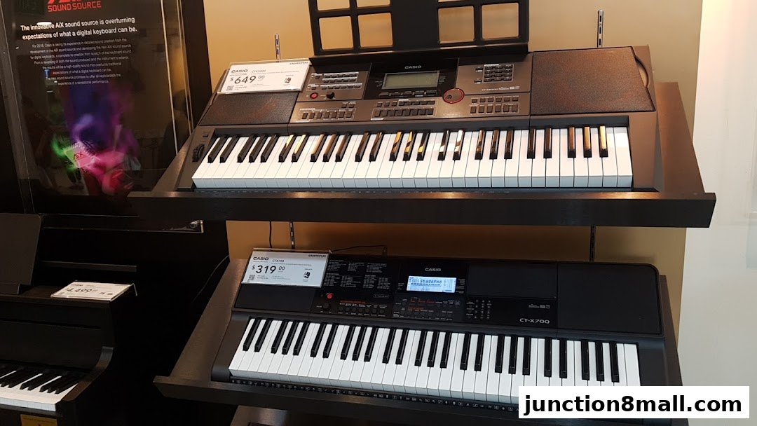 Two Casio digital keyboards are displayed on shelves, with pricing information visible.