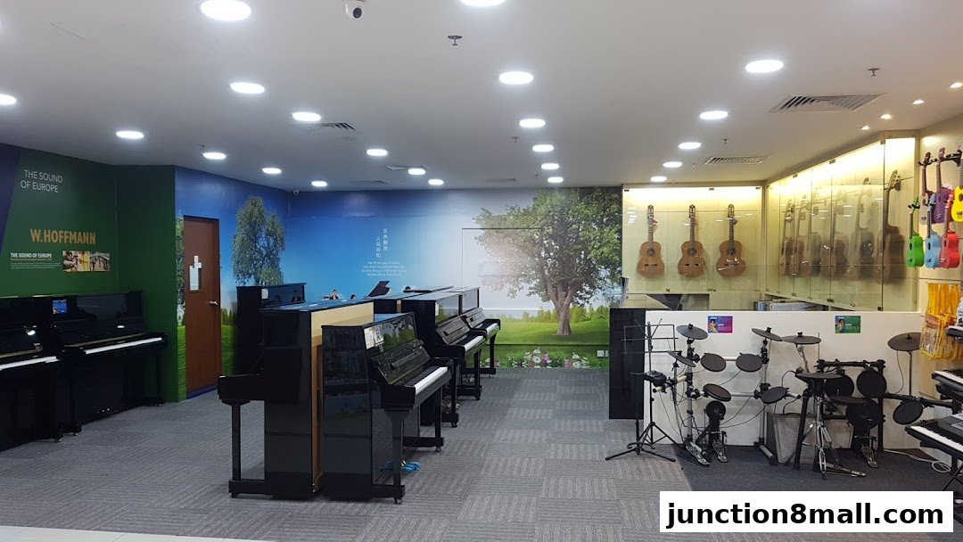 Interior of a music school showcasing pianos, guitars, and drum sets.
