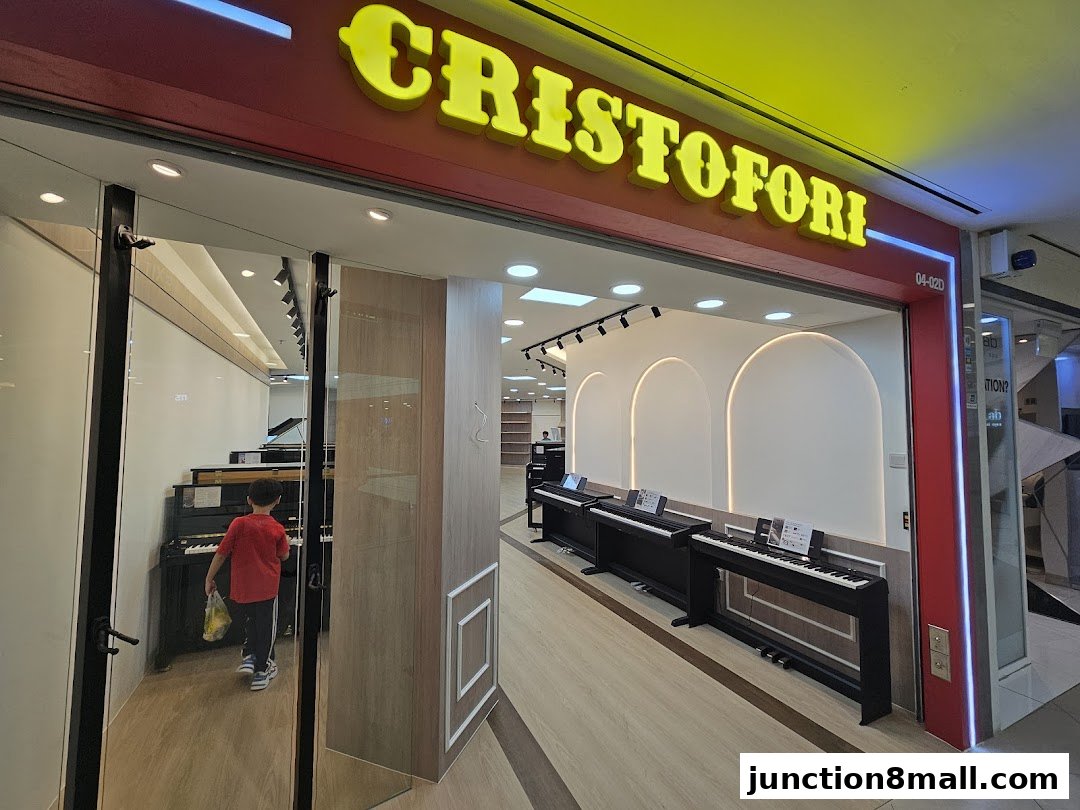 Entrance to Cristofori Music School, showcasing pianos and a young student.
