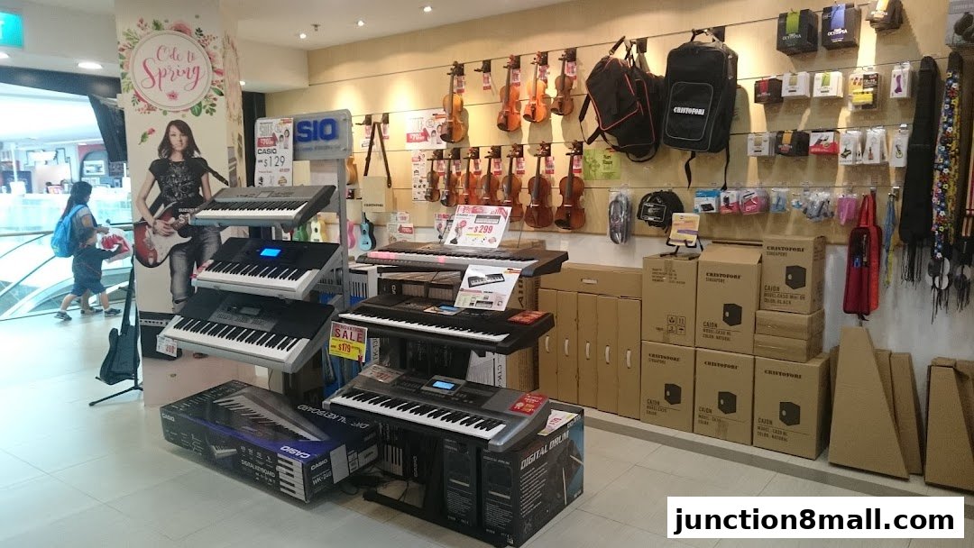 A music store interior displaying keyboards, violins, bags, and accessories.