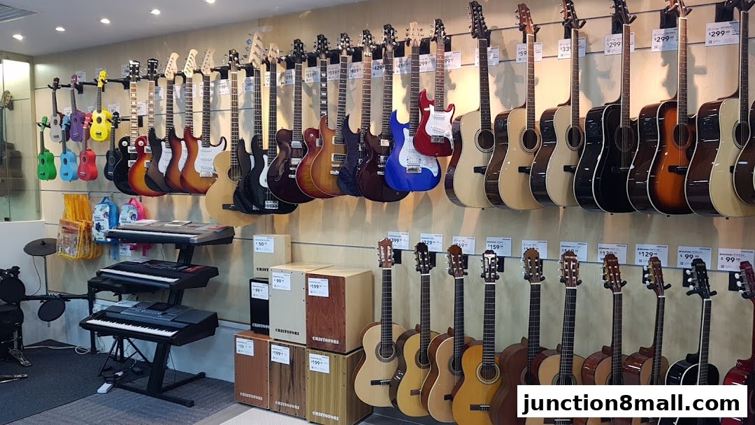 A wide selection of guitars and keyboards displayed on a wall and stands in a music store.