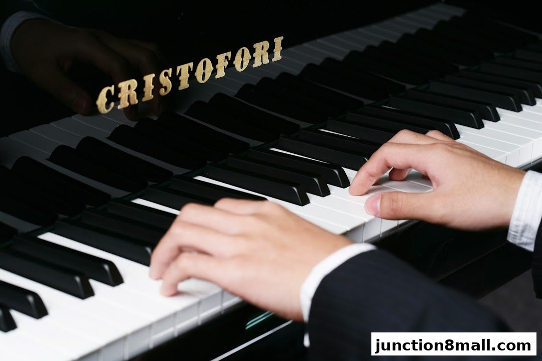 Hands playing a piano with the CRISTOFORI logo visible on the polished surface.