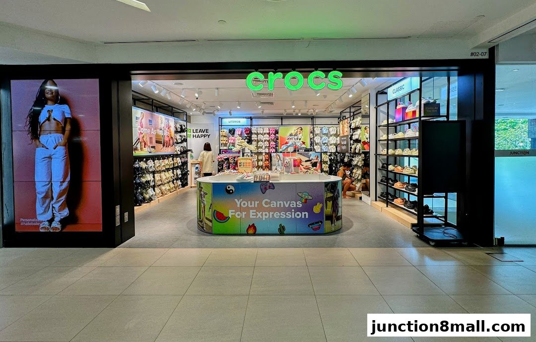 The Crocs store entrance displays colorful footwear and a large digital advertisement.