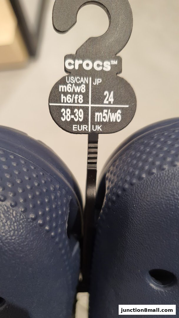 A close-up of a Crocs shoe tag showing size conversions for different regions.
