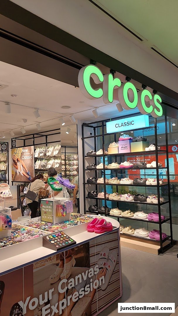 The Crocs store displays a variety of colorful shoes and Jibbitz charms, with a focus on the Classic collection.