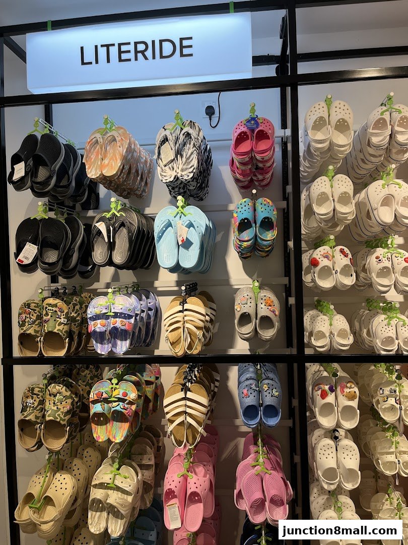 A display of various Crocs footwear, including clogs and sandals, in different colors and patterns.