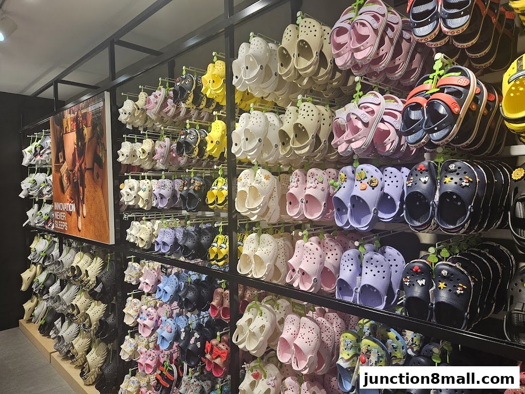 A wall display of colorful Crocs shoes in various styles and sizes.