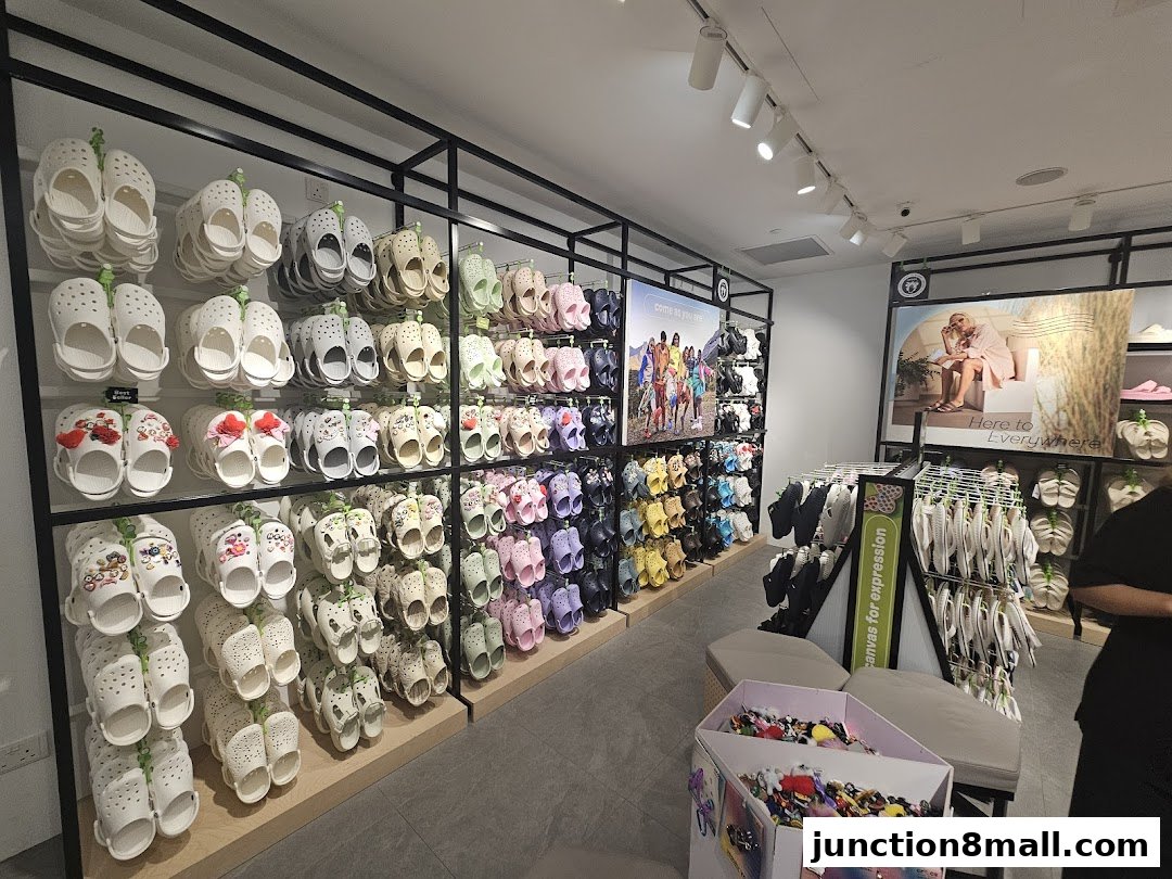 Interior view of a Crocs store showcasing a wide variety of colorful clogs and accessories.
