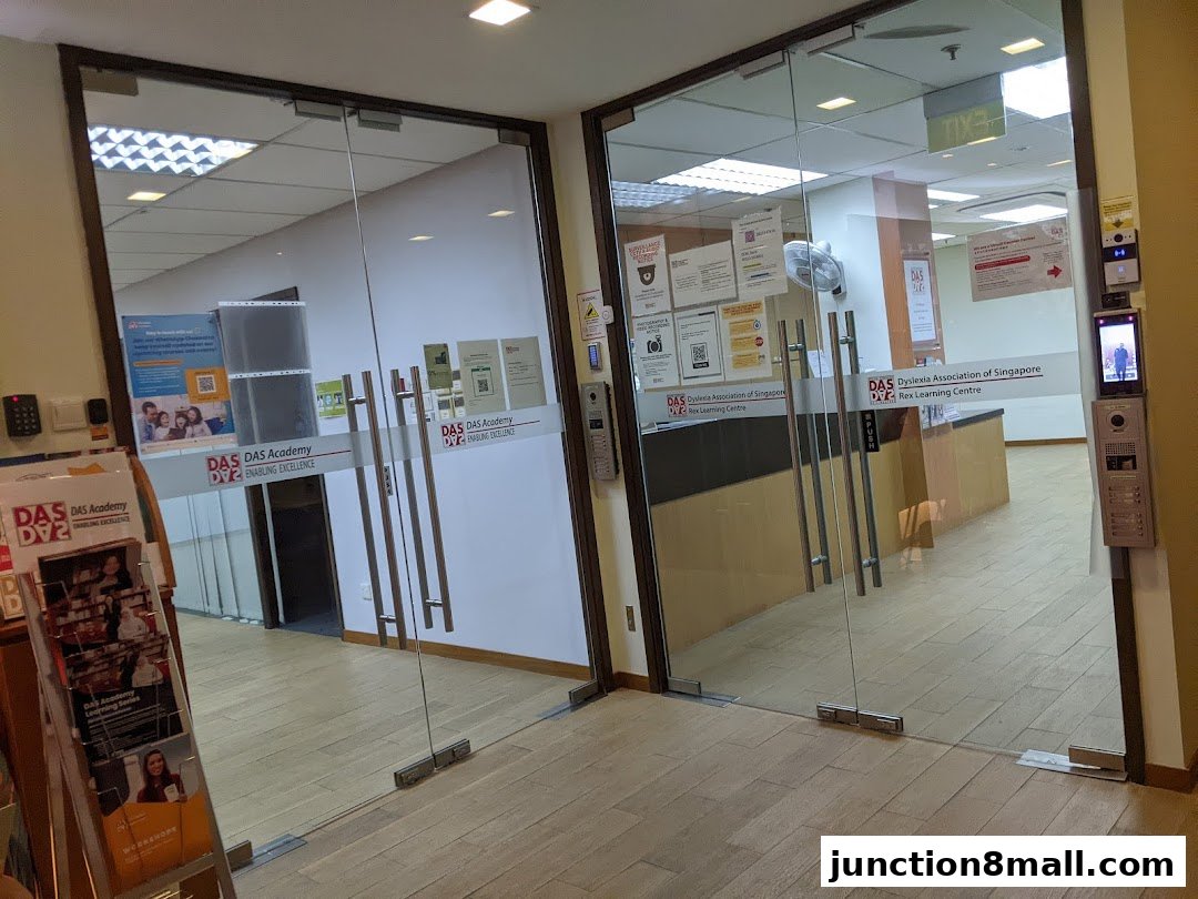 The entrance to DAS Academy, a learning center with glass doors and informational posters.