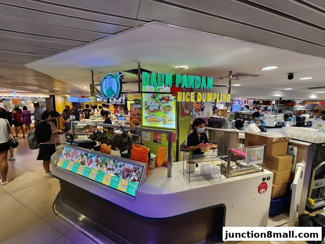 A food stall named Daun Pandan Rice Dumpling with staff serving customers.