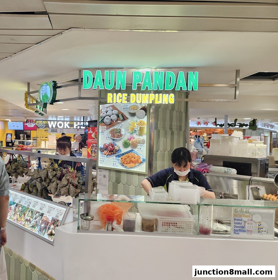 A food stall named Daun Pandan Rice Dumpling with staff preparing food and displayed dumplings.