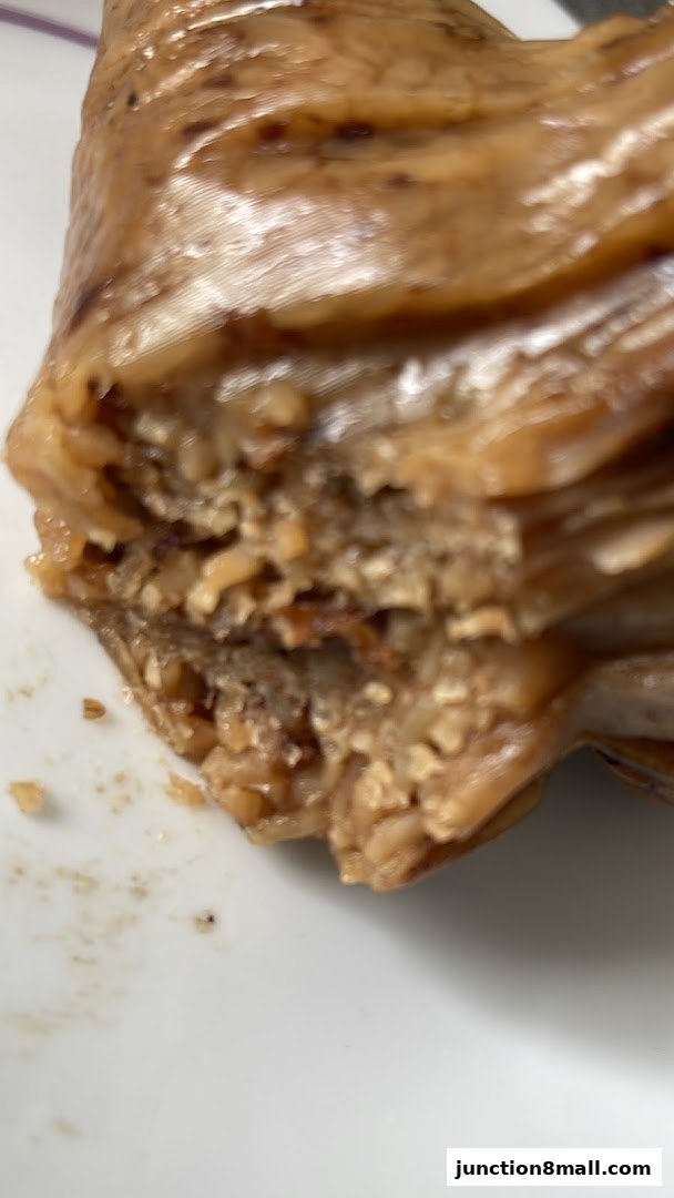 A close-up view of a layered rice dumpling, showcasing its texture and ingredients.