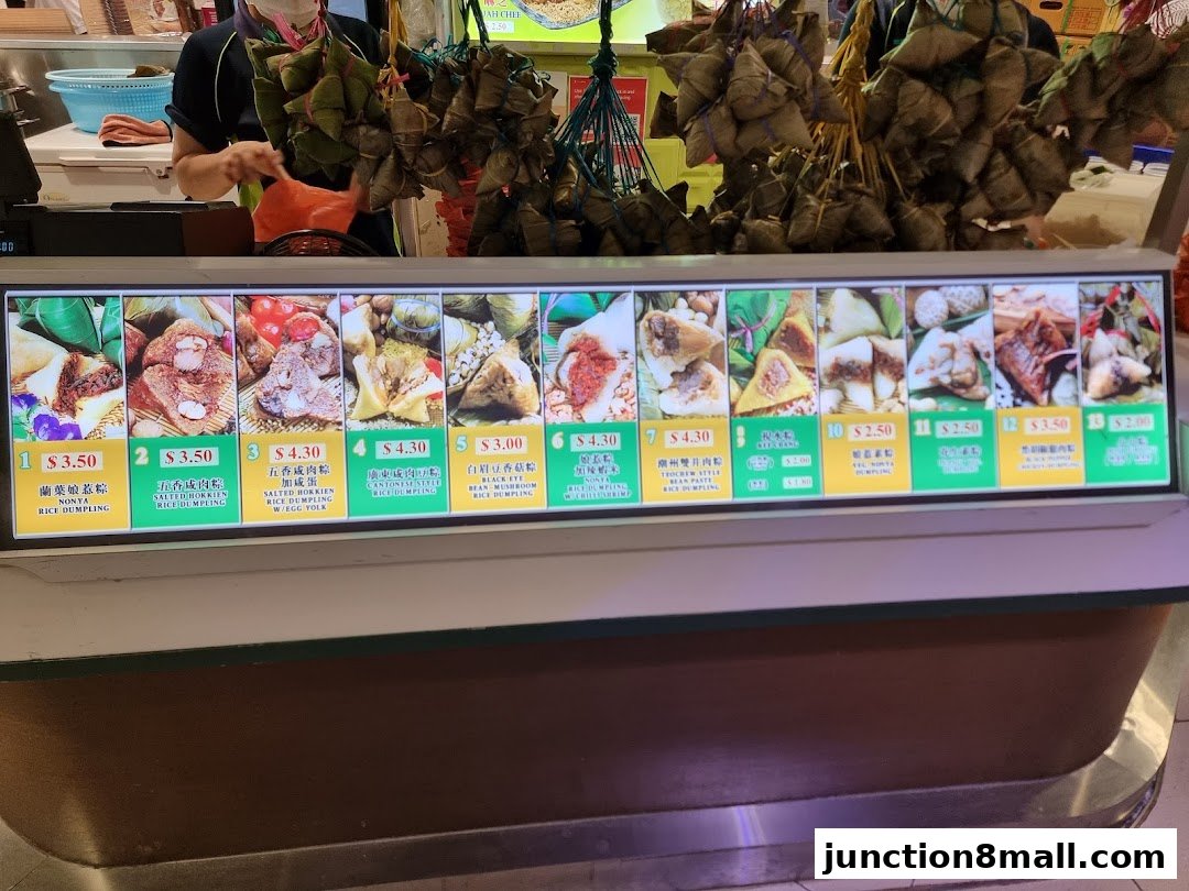 A display of various rice dumplings with their names and prices.