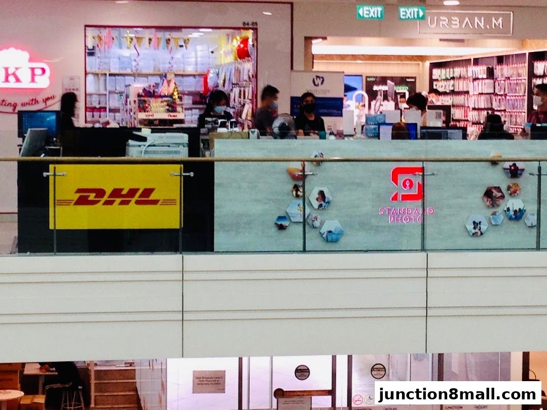 A DHL Express Service Point and Standard Photo shop with staff behind counters.