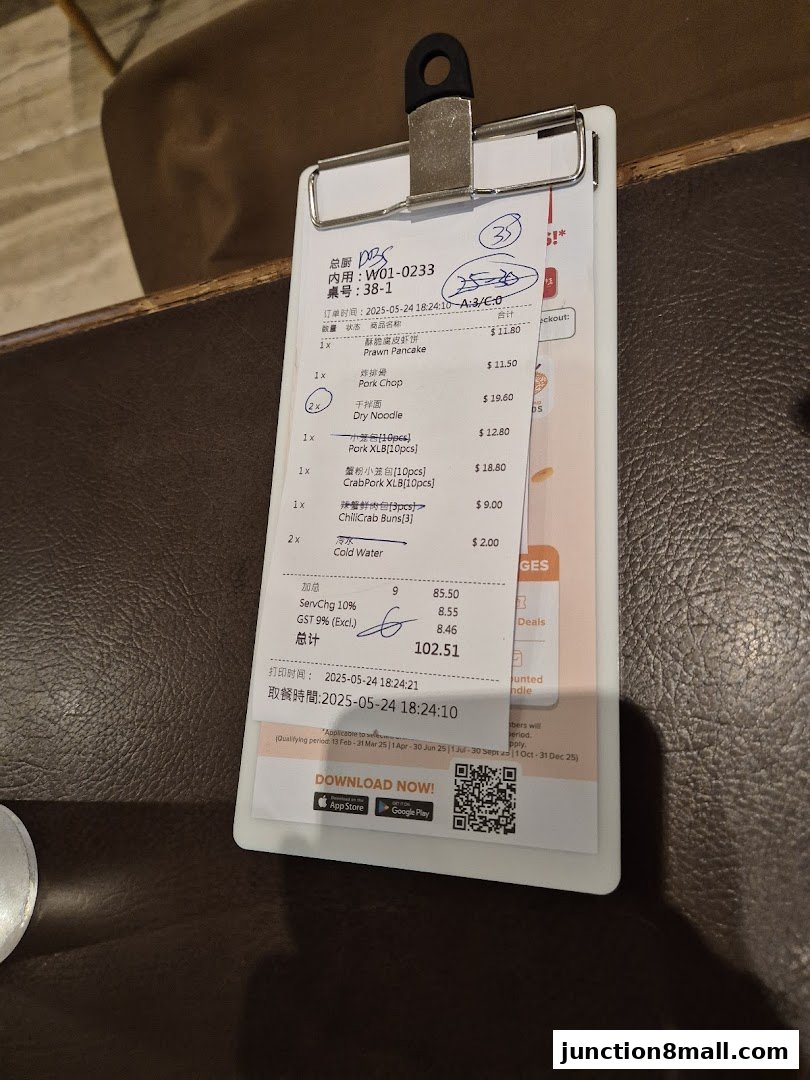 A close-up of a receipt from Din Tai Fung showing ordered food items and prices.